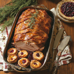 Maple-Brined Whole Pork Loin Roast with Mini Cranberry Pies on a tray