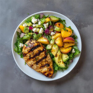 Grilled Greek Marinated Chicken Breast with Peach and Endive Salad on a plate