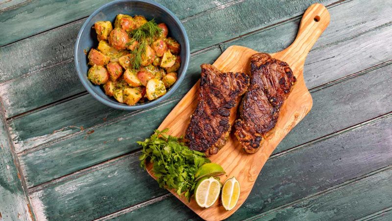 marinated steak tips with herby potato salad