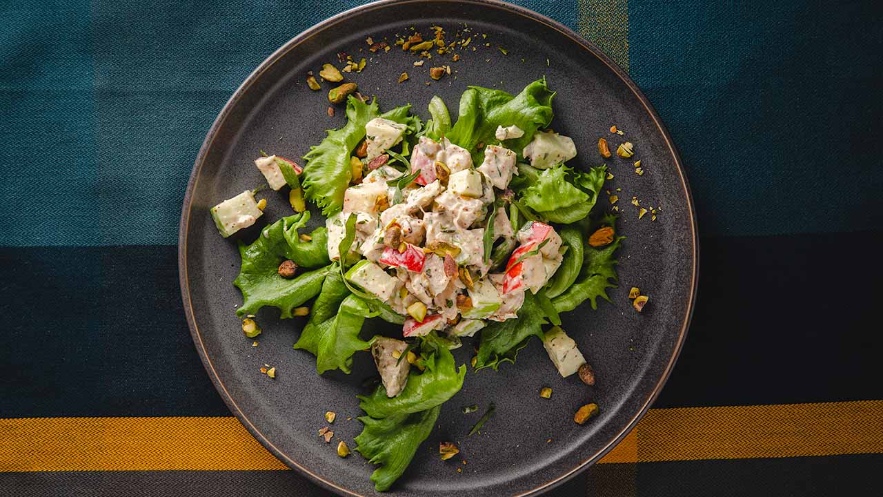 tarragon and apple chicken salad on a bed of greens