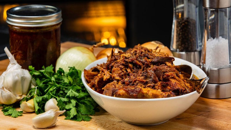 BBQ pulled pork in a bowl surrounded by ingredients