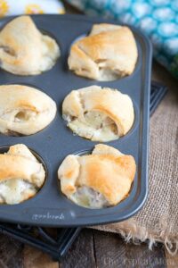a muffin tin with fresh baked turkey dumplings