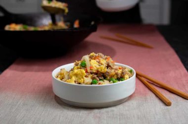 bowl of ground pork fried rice on a table with chopsticks
