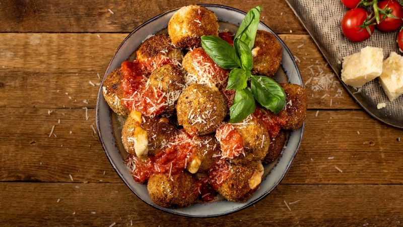 Chicken Parmesan meatballs stacked in a bowl