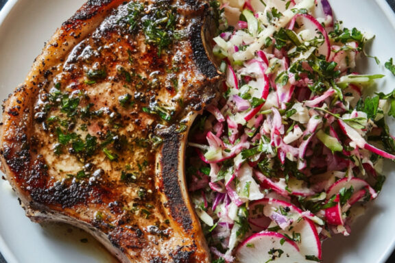 Herby Pork Chops with Fennel and Radish Slaw on a plate