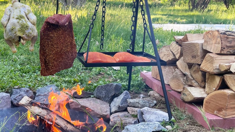 grilling steak chicken and salmon over open fire