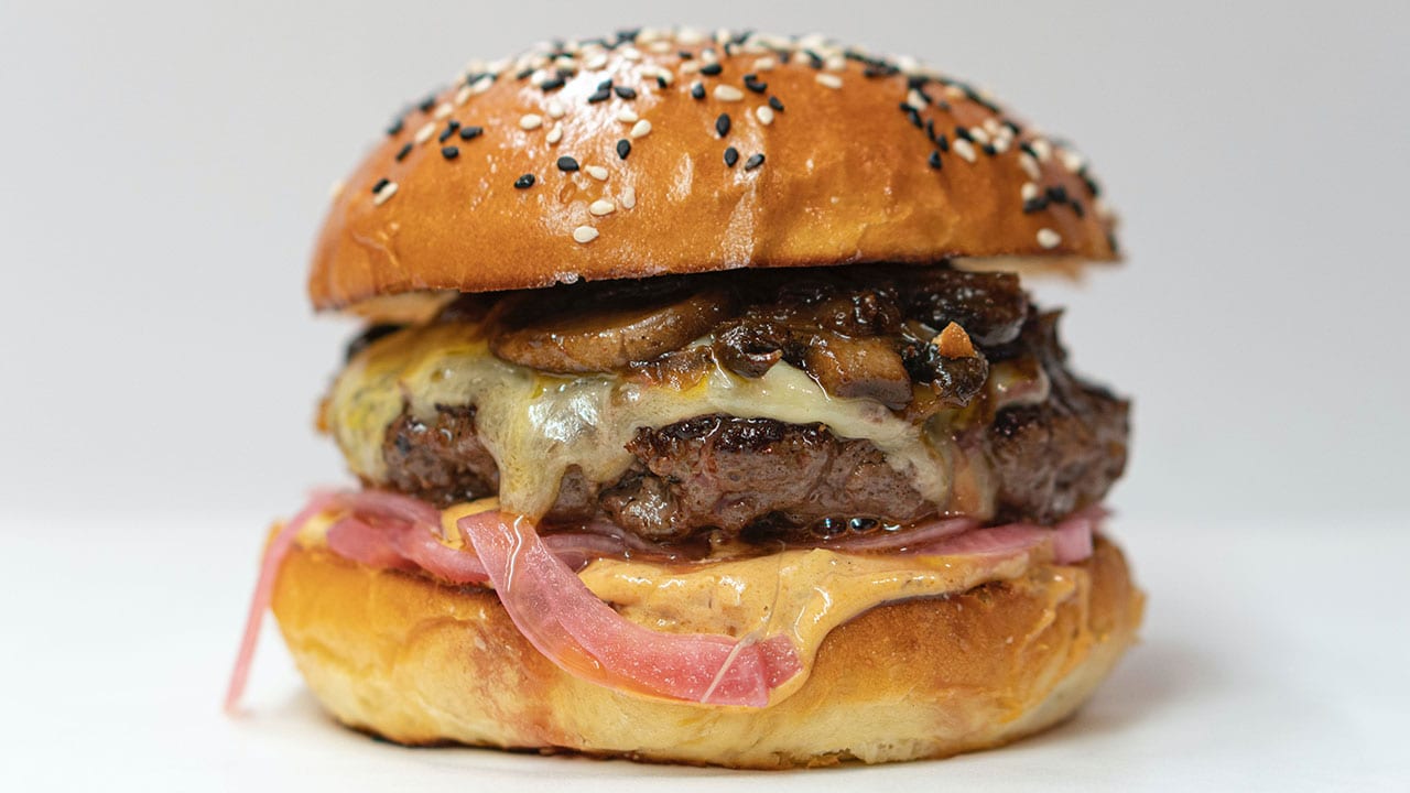 cheeseburger with mushrooms and pickled onions