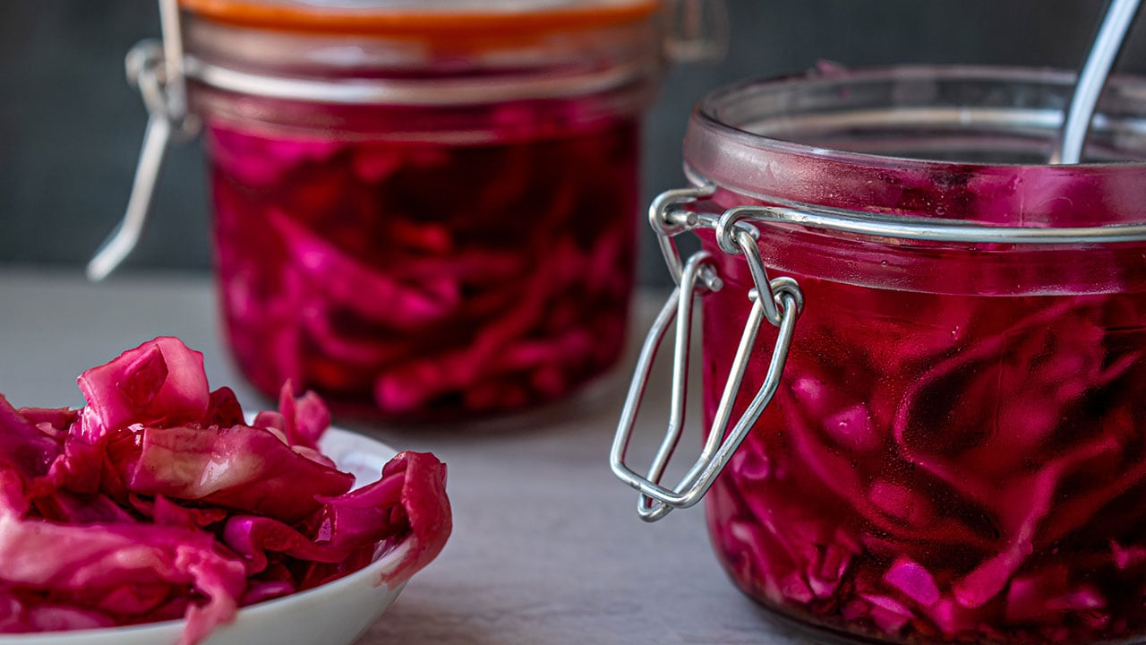pickled red cabbage in jars and a bowl