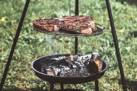 steak roasting over open fire