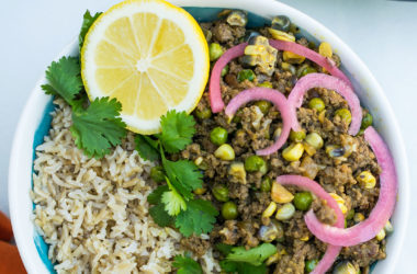 picadillo criollo in a bowl with a lemon wedge