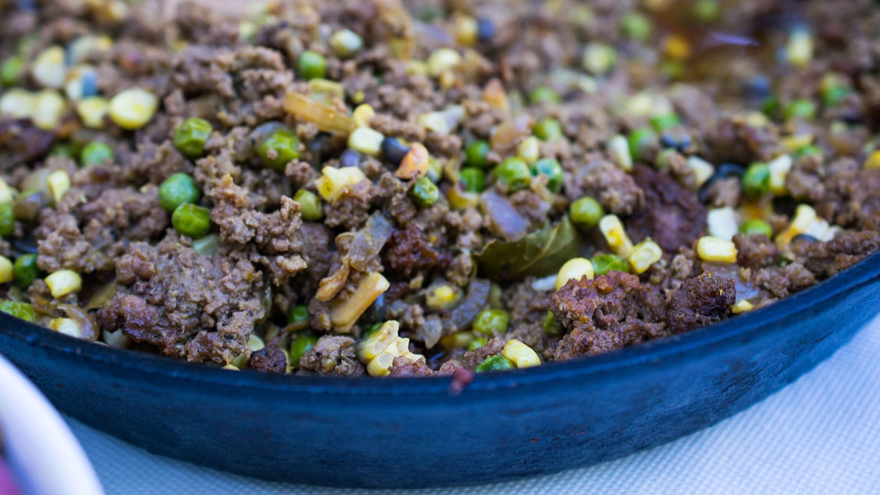 close up of picadillo criollo cooking in a skillet