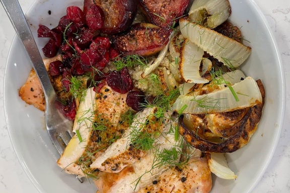 roasted chicken, fennel, cranberries, figs, and quinoa in a bowl