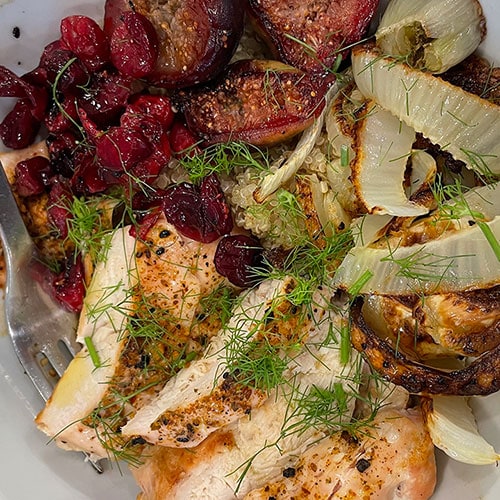 roasted chicken, fennel, figs, cranberries, and quinoa in a bowl