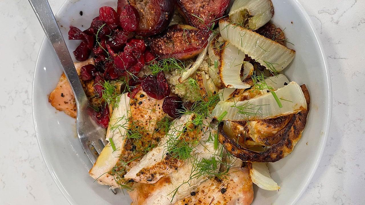 roasted chicken, fennel, cranberries, figs, and quinoa in a bowl