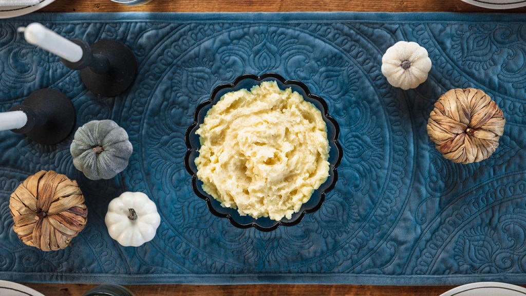 a bowl of mashed potatoes in the center of the table