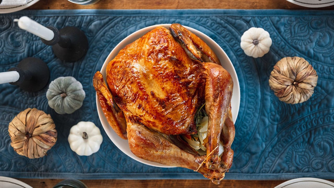 Golden roasted turkey with meat thermometer, close up Stock Photo