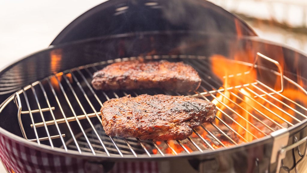 frozen steaks cooking on two hot zones