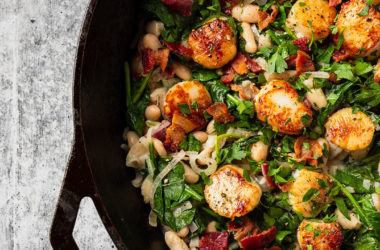 scallops spinach beans and bacon in a skillet