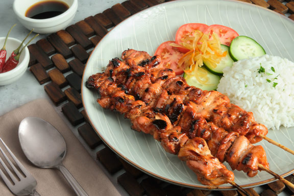 bbq filipino chicken skewers with rice and pickled green papaya