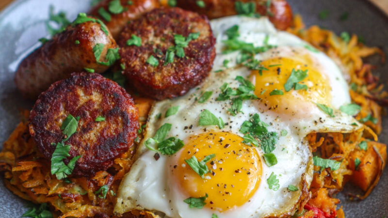 Sausages, Sweet Potato-Shallot Hash Browns and Eggs on a plate