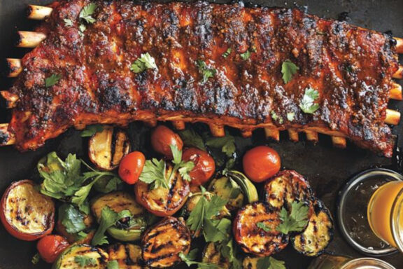 st. louis ribs with veggies in a serving plate