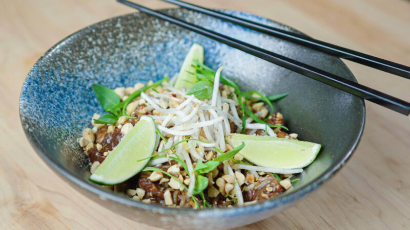 Chicken Pad Thai in a bowl with chopsticks