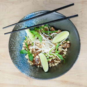 Chicken Pad Thai in a bowl with chopsticks