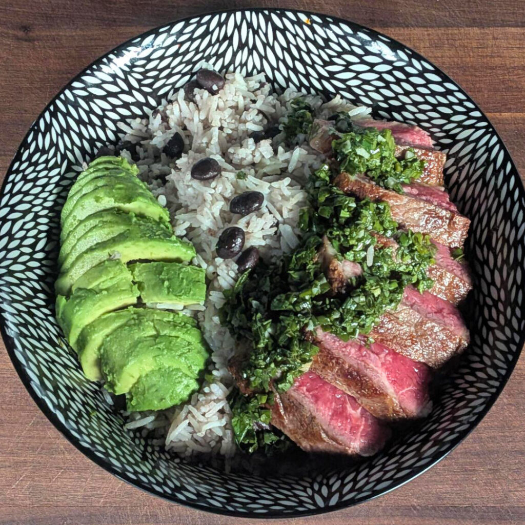 Image of steak bowl with rice, beans, avocado